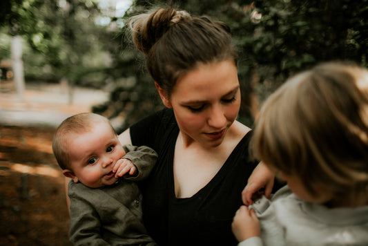 Busy overwhelmed mom with kids staying patient