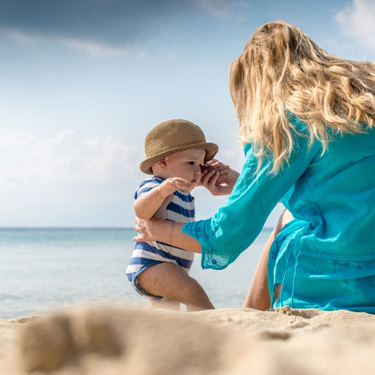 summer beach mom holding baby