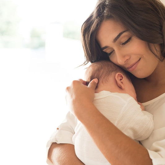 Celebrating World Breastfeeding Week by Honoring Hardworking Moms. happy mom holding newborn baby